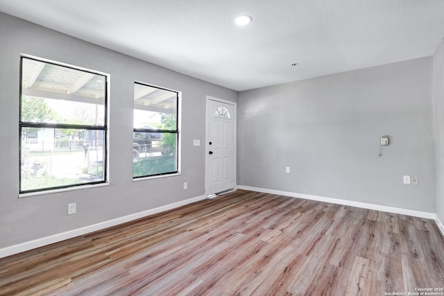 empty room with light hardwood / wood-style floors