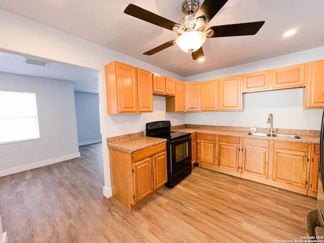 kitchen featuring light wood-type flooring, black electric range oven, ceiling fan, and sink