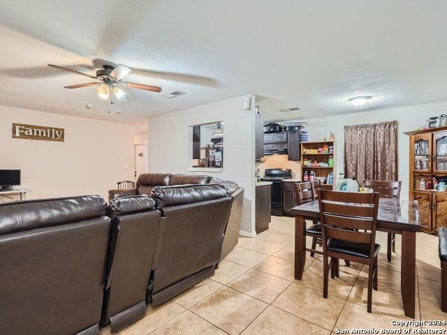 tiled living room with ceiling fan