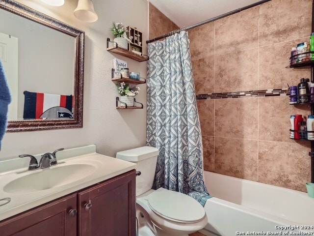 full bathroom with shower / tub combo, vanity, and toilet