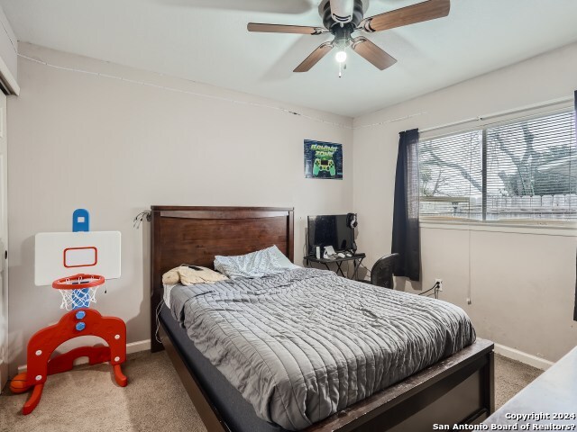 carpeted bedroom featuring ceiling fan