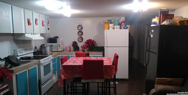 kitchen with white cabinetry, white appliances, blue cabinets, and range hood