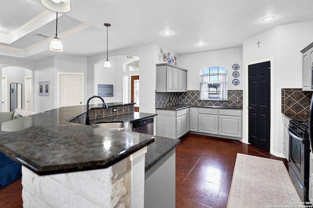 kitchen featuring appliances with stainless steel finishes, gray cabinetry, a tray ceiling, sink, and pendant lighting