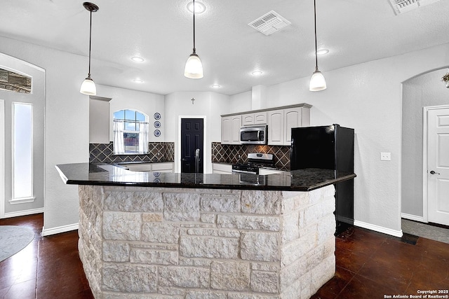 kitchen featuring gray cabinetry, decorative light fixtures, stainless steel appliances, and tasteful backsplash