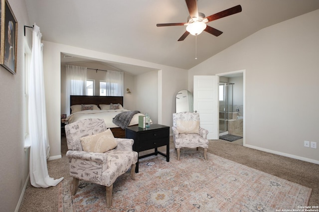 bedroom featuring ceiling fan, light colored carpet, ensuite bathroom, and vaulted ceiling