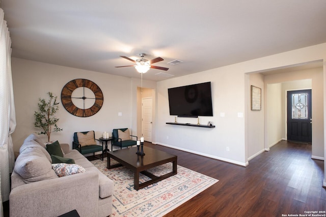 living room featuring dark hardwood / wood-style floors and ceiling fan