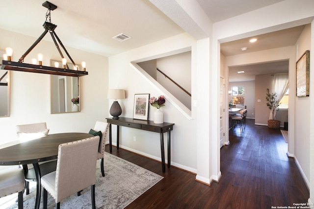 dining room with a chandelier and dark hardwood / wood-style flooring