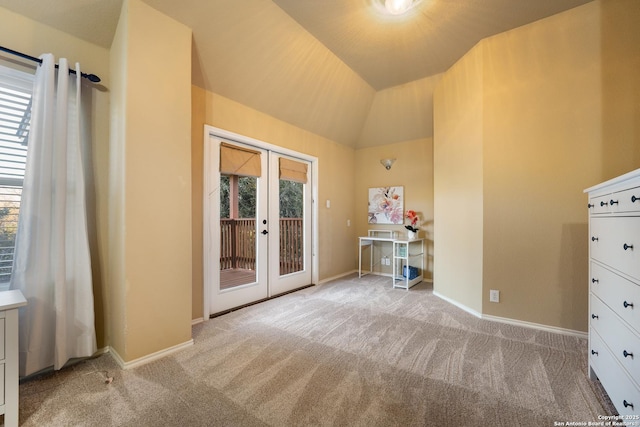 interior space featuring french doors, access to outside, lofted ceiling, and light colored carpet