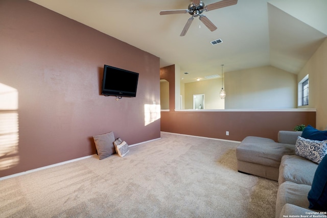 carpeted living room with ceiling fan and lofted ceiling