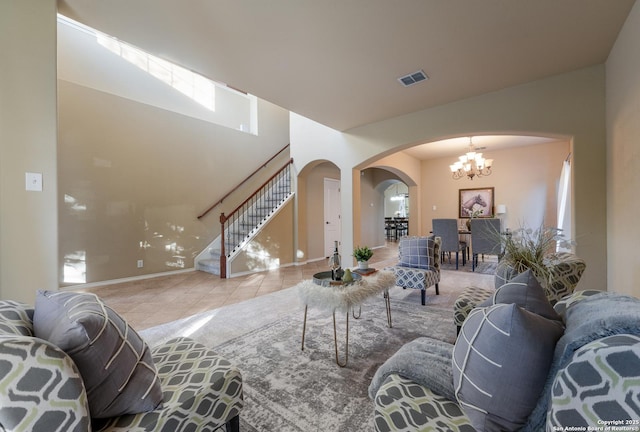 living room featuring a notable chandelier and light tile patterned floors