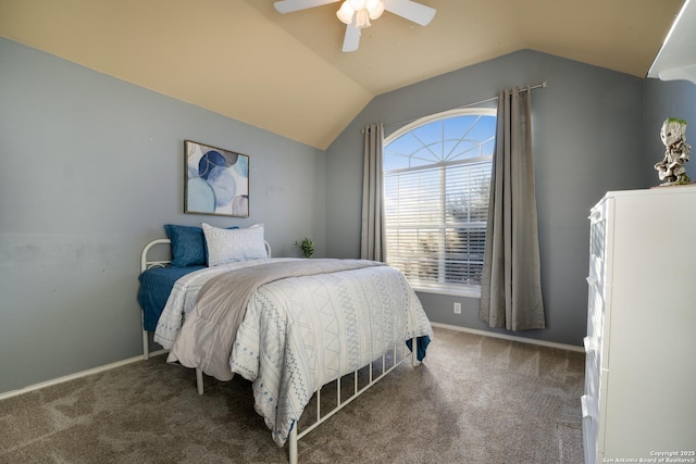 carpeted bedroom with ceiling fan and vaulted ceiling