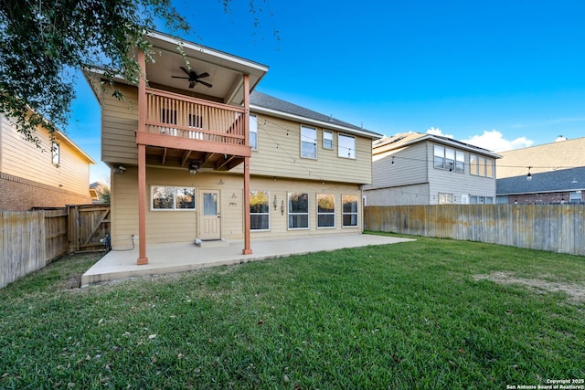 rear view of house with a lawn, a patio area, and a balcony