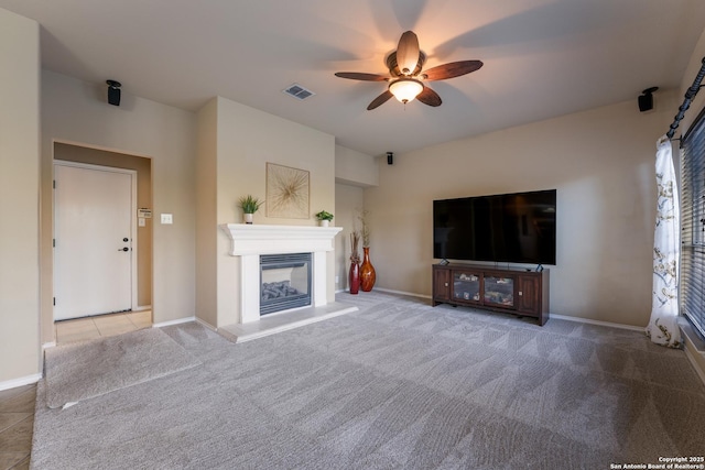 unfurnished living room with light colored carpet and ceiling fan