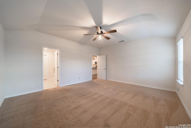 unfurnished room featuring ceiling fan, light colored carpet, and vaulted ceiling