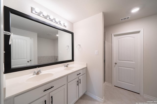 bathroom with vanity, tile patterned floors, and a shower with shower door