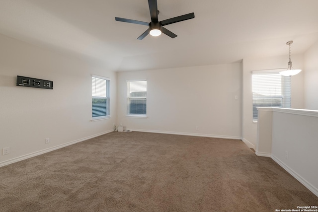 carpeted empty room with vaulted ceiling and ceiling fan