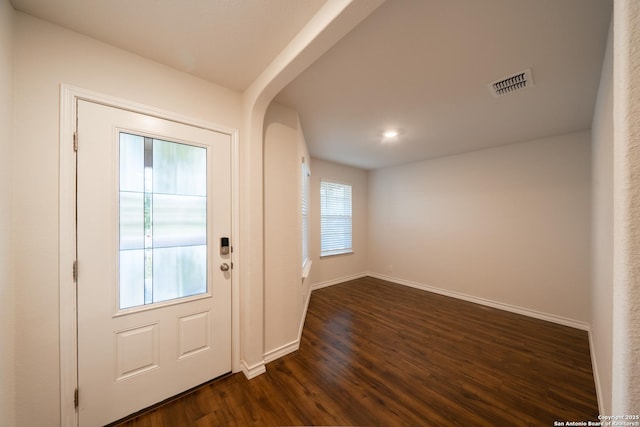 entryway with dark hardwood / wood-style flooring