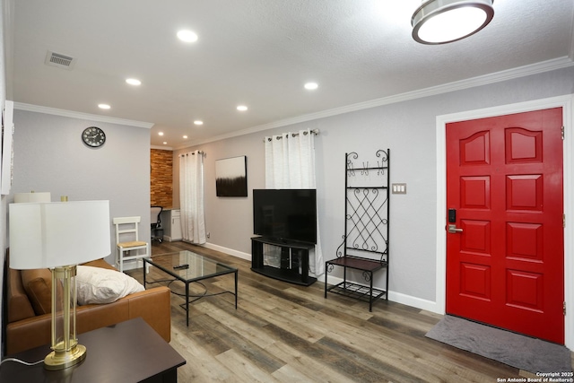 living room featuring crown molding and hardwood / wood-style flooring