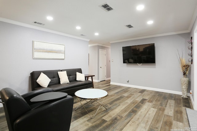 living room with wood-type flooring and ornamental molding