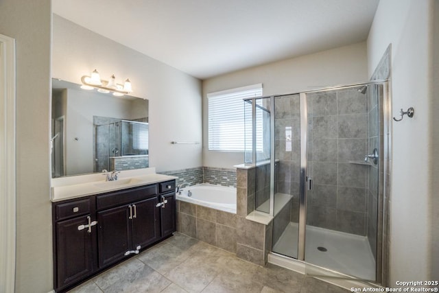 bathroom with tile patterned floors, vanity, and separate shower and tub