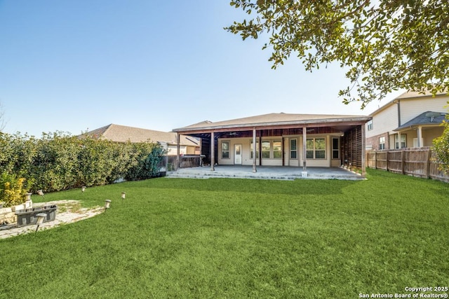 back of property with a patio and a lawn