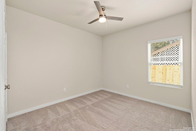 carpeted spare room with ceiling fan