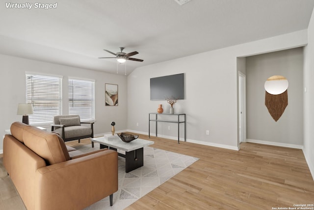 living room featuring light wood-type flooring and ceiling fan