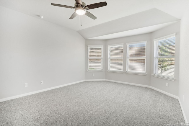 spare room featuring ceiling fan, carpet floors, and vaulted ceiling