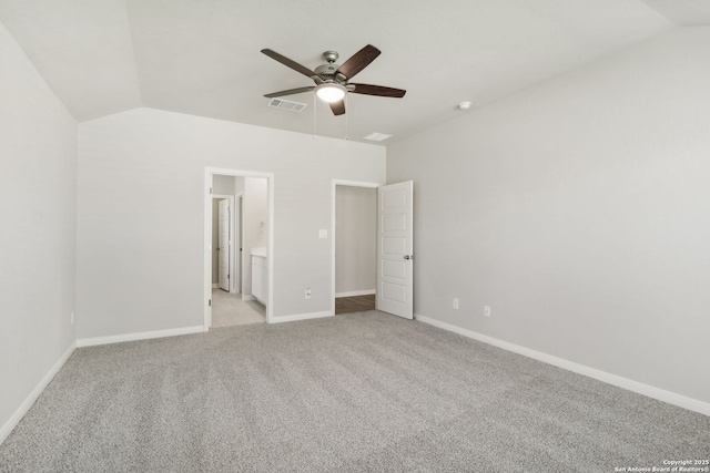 unfurnished bedroom with ensuite bathroom, ceiling fan, light colored carpet, and lofted ceiling