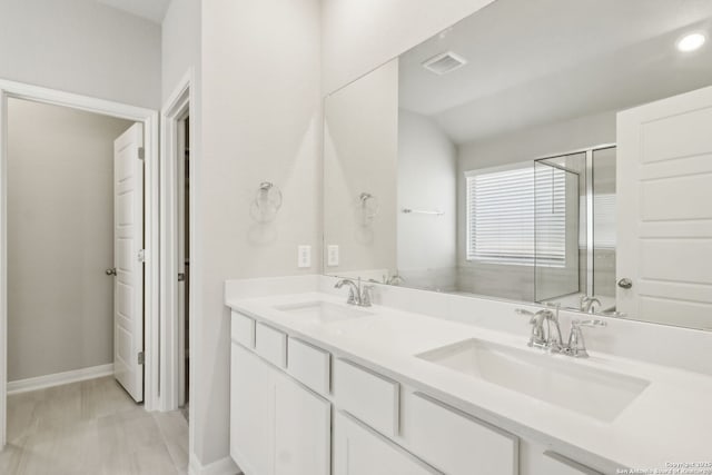 bathroom featuring vanity and vaulted ceiling