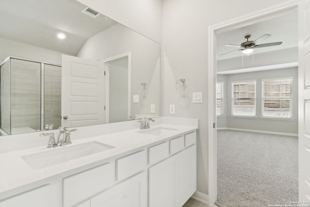 bathroom with ceiling fan, vanity, lofted ceiling, and walk in shower