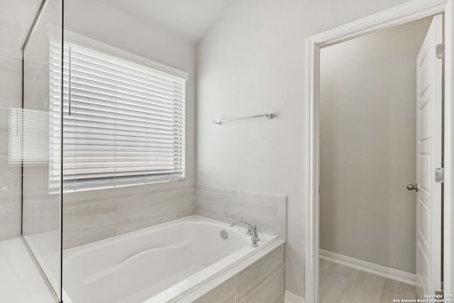 bathroom featuring tiled bath