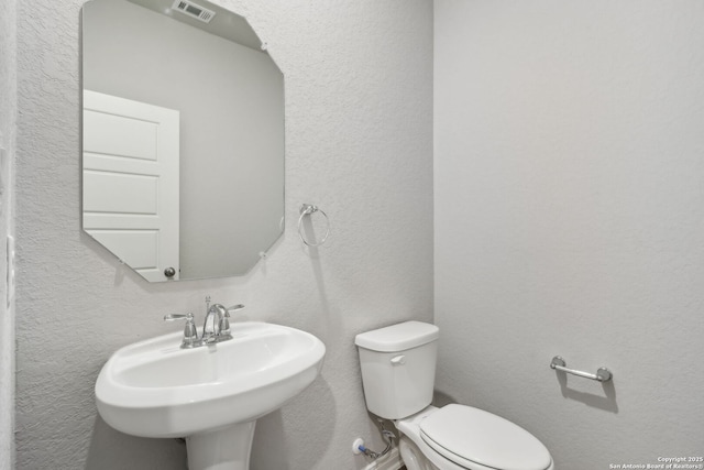 bathroom featuring sink and toilet