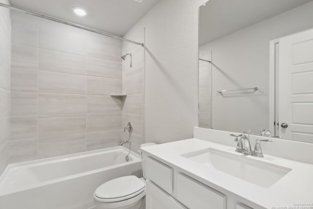 full bathroom with vanity, toilet, and tiled shower / bath combo