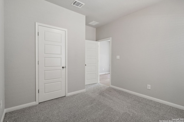 unfurnished bedroom featuring light colored carpet