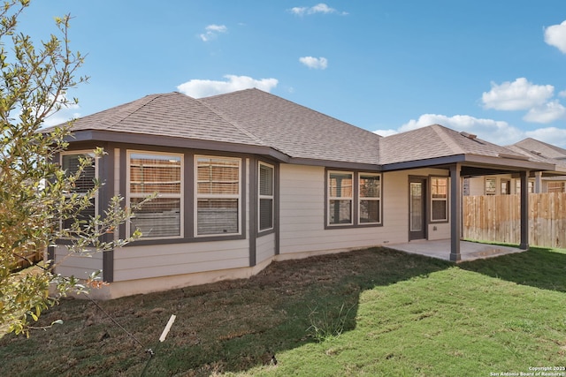 rear view of property featuring a patio area and a lawn