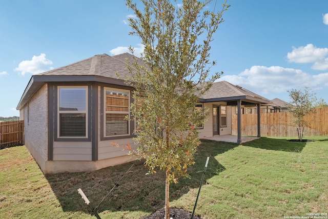 rear view of property with a patio area and a yard