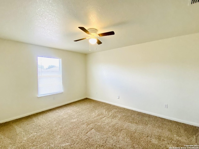 unfurnished room featuring ceiling fan and carpet floors