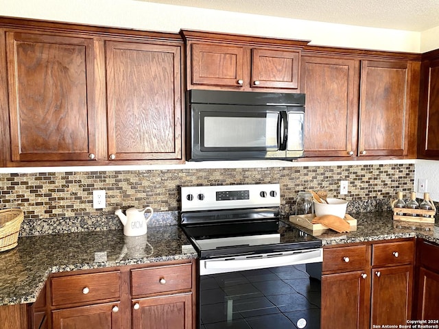 kitchen featuring decorative backsplash, a textured ceiling, dark stone countertops, and stainless steel electric range