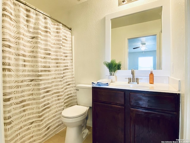 bathroom with tile patterned floors, vanity, toilet, and ceiling fan