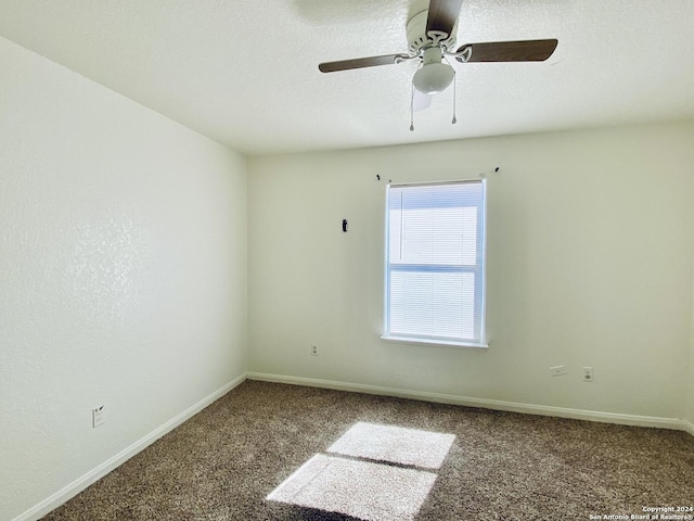 spare room featuring ceiling fan and carpet floors