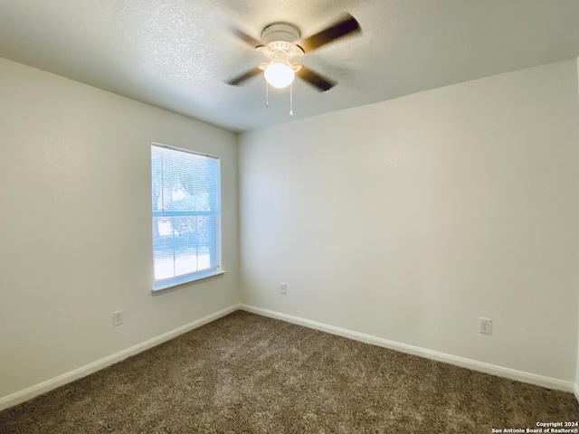 empty room with carpet flooring and ceiling fan