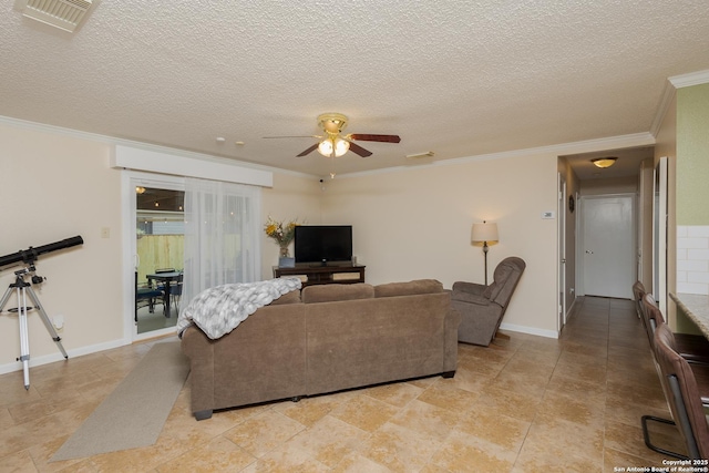 living room featuring ceiling fan, a textured ceiling, and ornamental molding