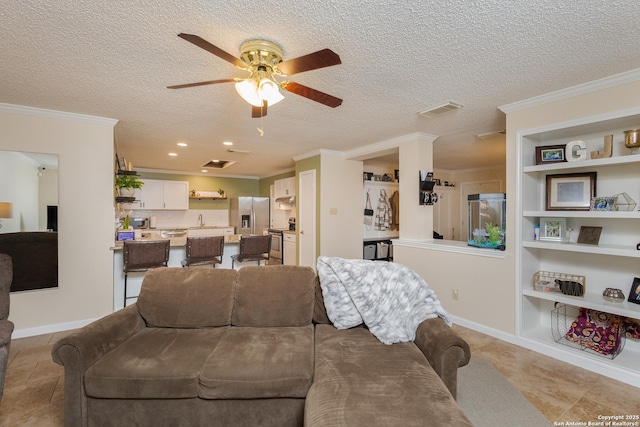 living room featuring built in shelves, a textured ceiling, and ceiling fan