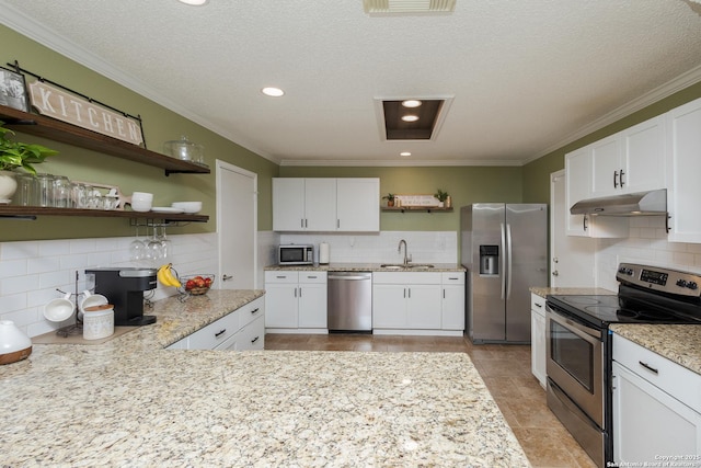 kitchen featuring appliances with stainless steel finishes, backsplash, and white cabinetry