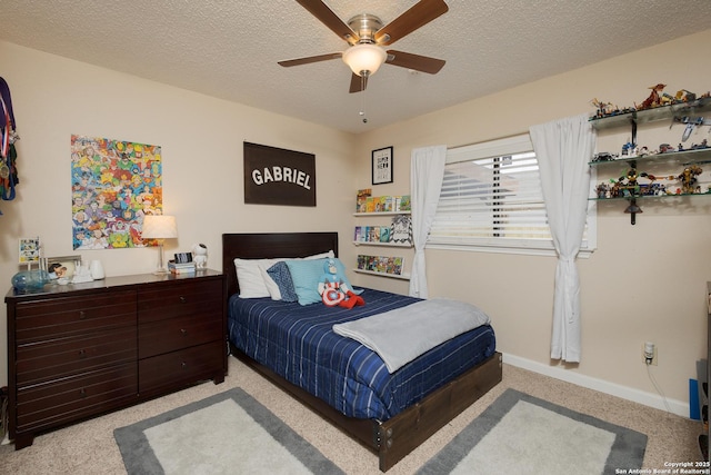 bedroom featuring ceiling fan, light carpet, and a textured ceiling