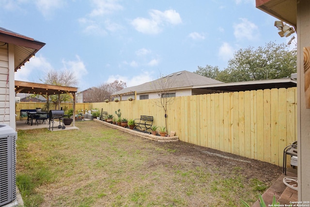 view of yard with central AC and a patio area