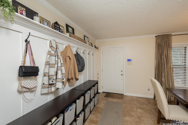 mudroom featuring a textured ceiling, crown molding, and light tile patterned flooring