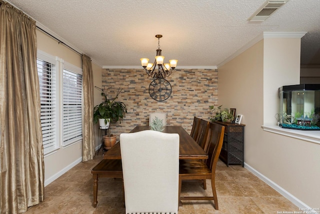 dining area with a textured ceiling, a notable chandelier, and crown molding