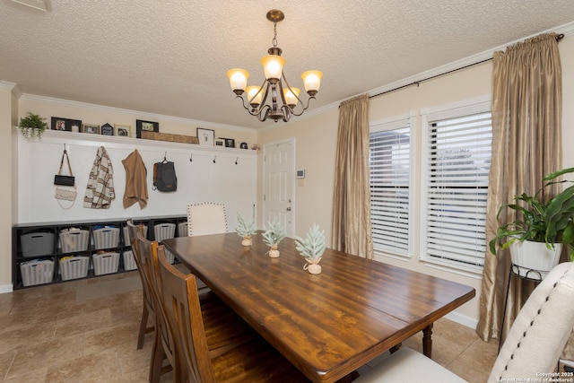 dining room with a textured ceiling, crown molding, and an inviting chandelier